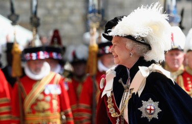 Queen Elizabeth II in a modern St. George's Day parade wearing the dark blue mantle (cape) with the insignia of the Noble Order of the Garter on the left shoulder